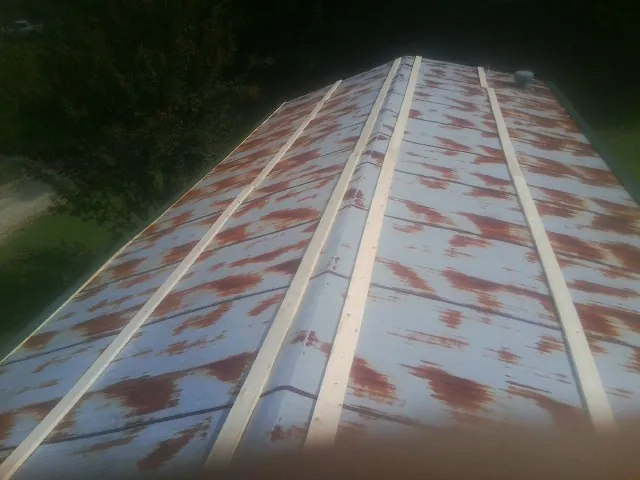 Rusted metal roof panels with new wood purlins before replacement — Storm Damage Roof Repair in Dickson by Roofing Brothers